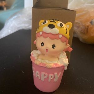 Baby girl figurine with tiger hat